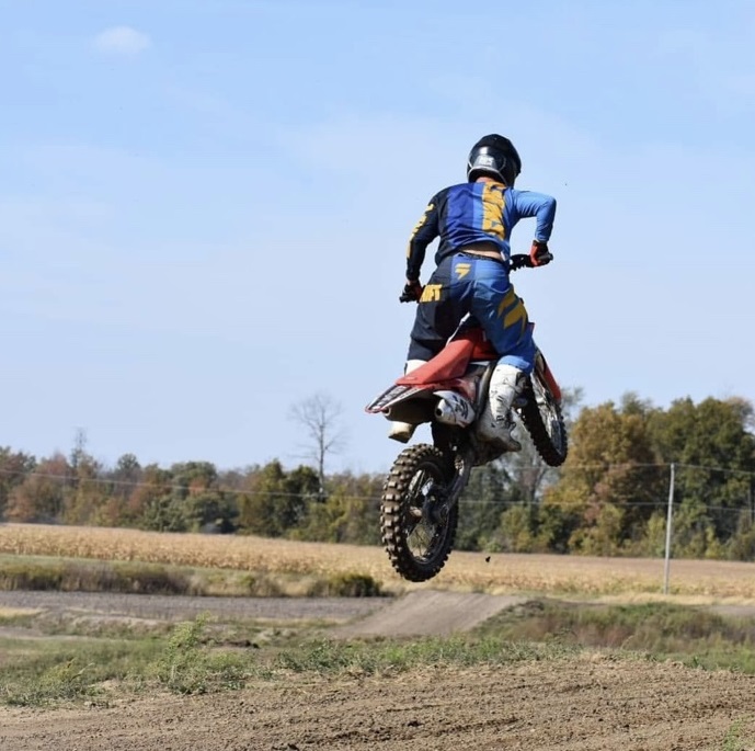 A person on a dirt bike jumping in the air.
